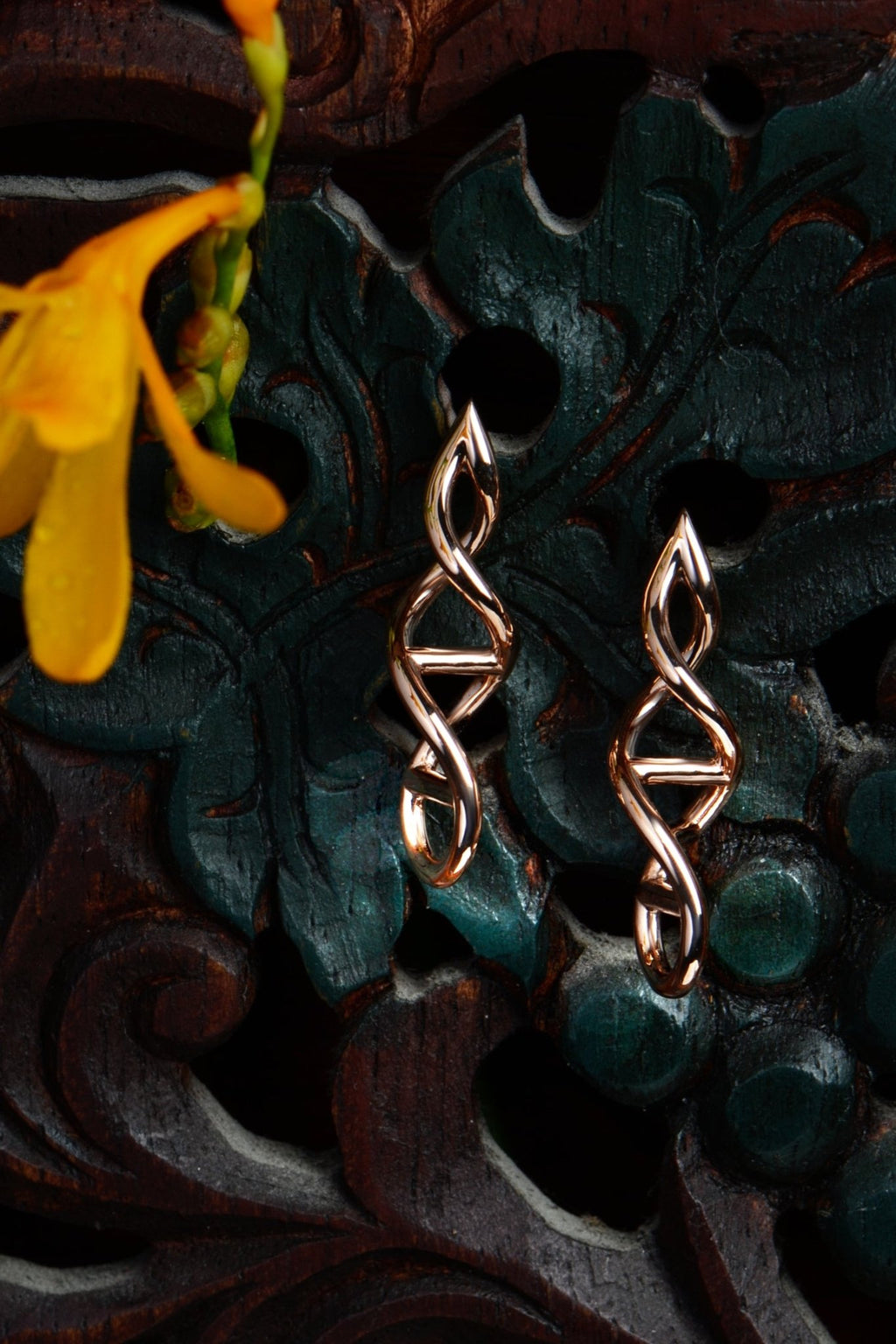 9ct rose gold Designer Genes drop  earrings by Christine Sadler shown on a black carved jewellery box — a meaningful gift to celebrate the bonds that matter most to you.