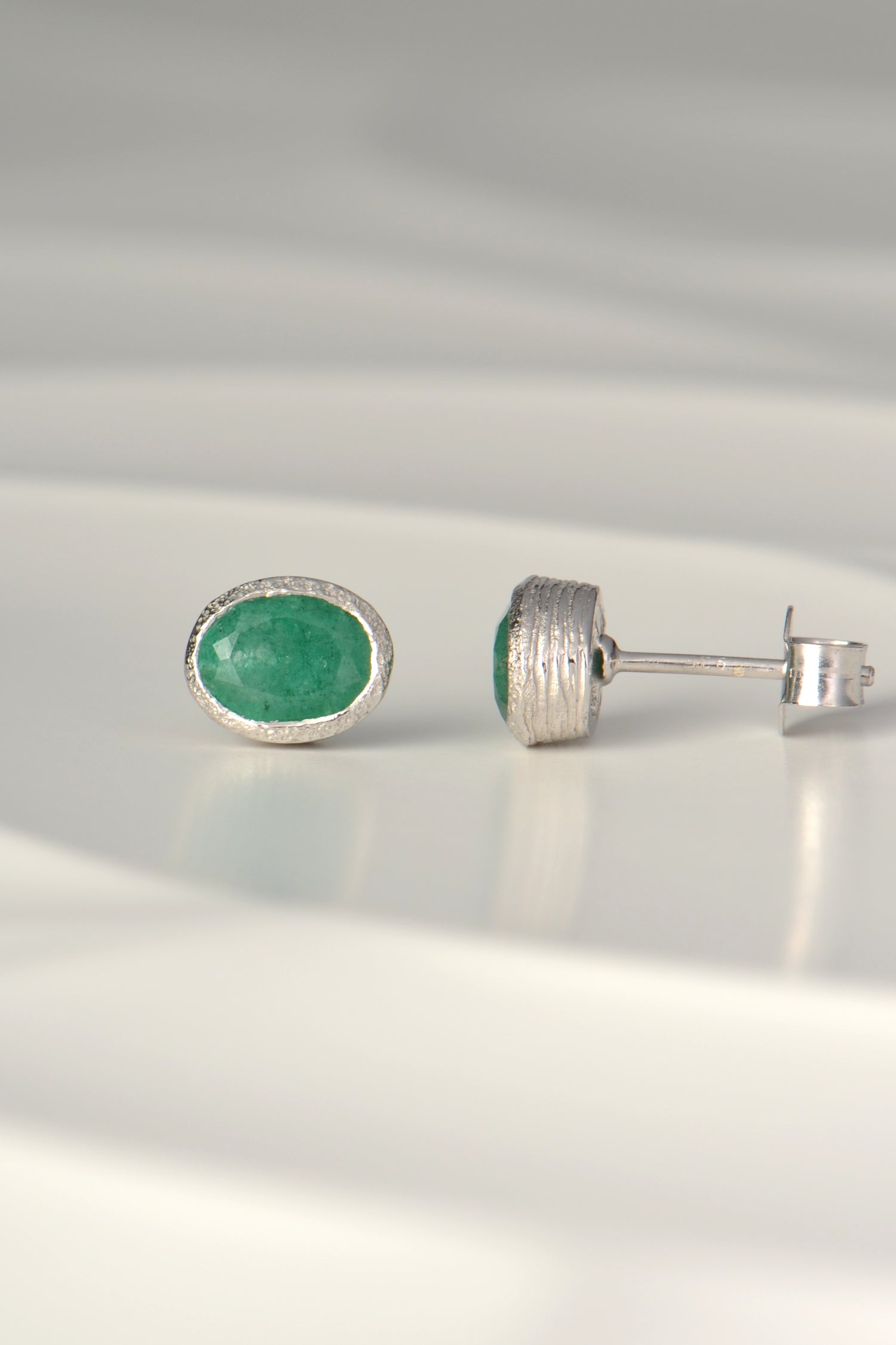 handmade silver and oval emerald stud earrings, the birthstone for May
