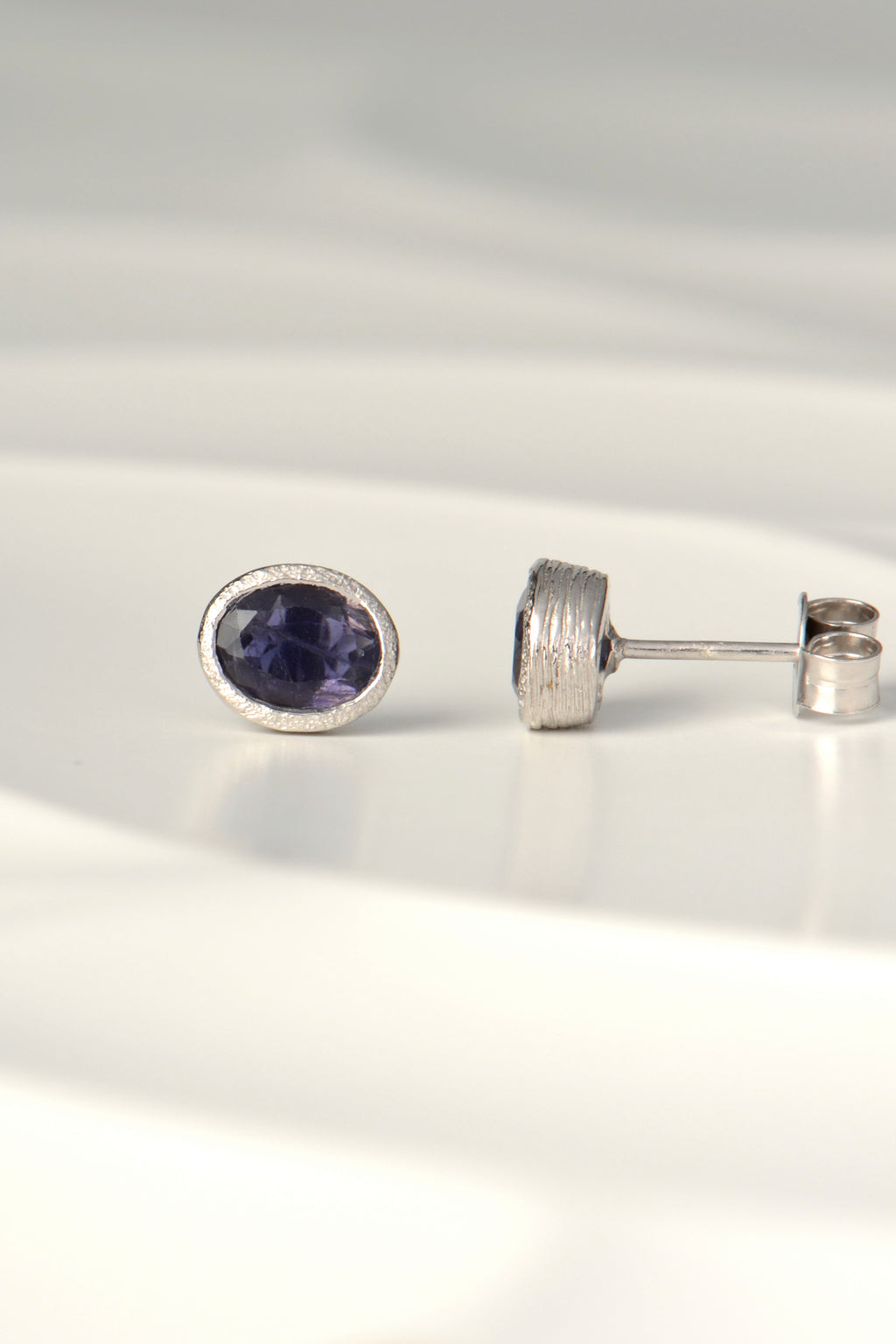 Oval blue sapphire stud earrings in silver, the birthstone for September