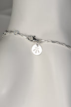 modern real silver designer bracelet that can be adjusted in length showing strong clasp with designer Christine Sadler's logo tag