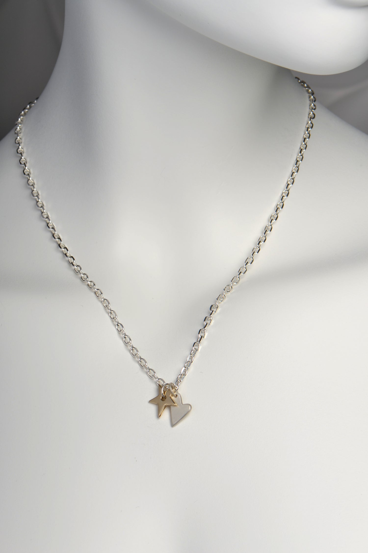 designer handmade necklace with a 9ct yellow gold star and silver heart pendant