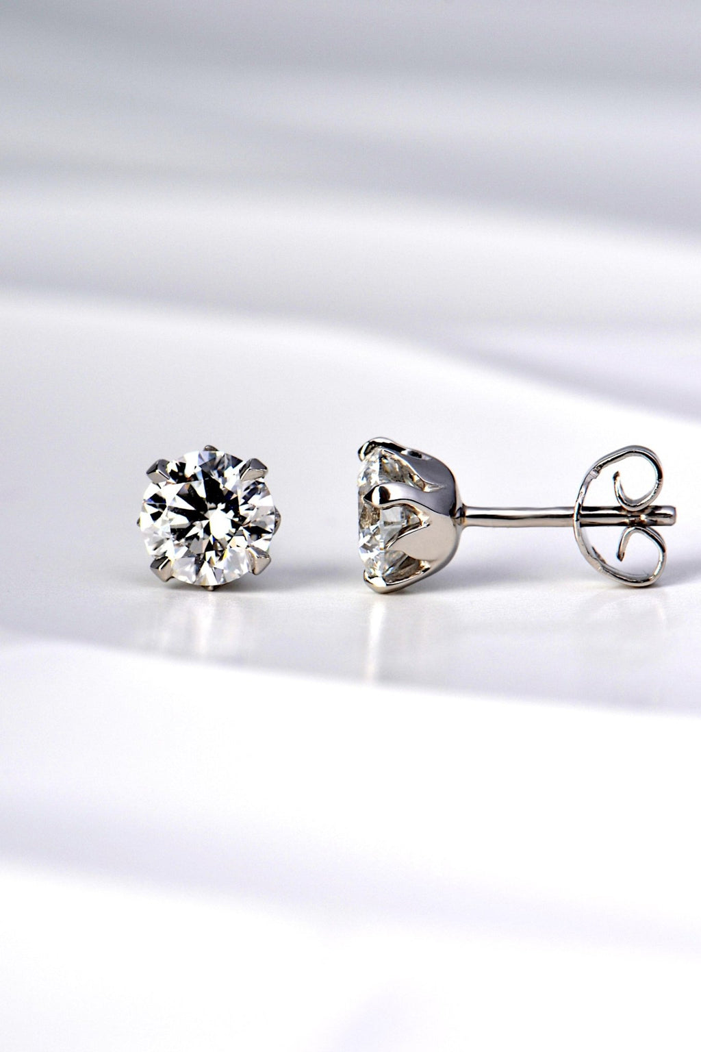 tiny platinum flame two carat lab diamond earrings exclusively available from Christine Sadler