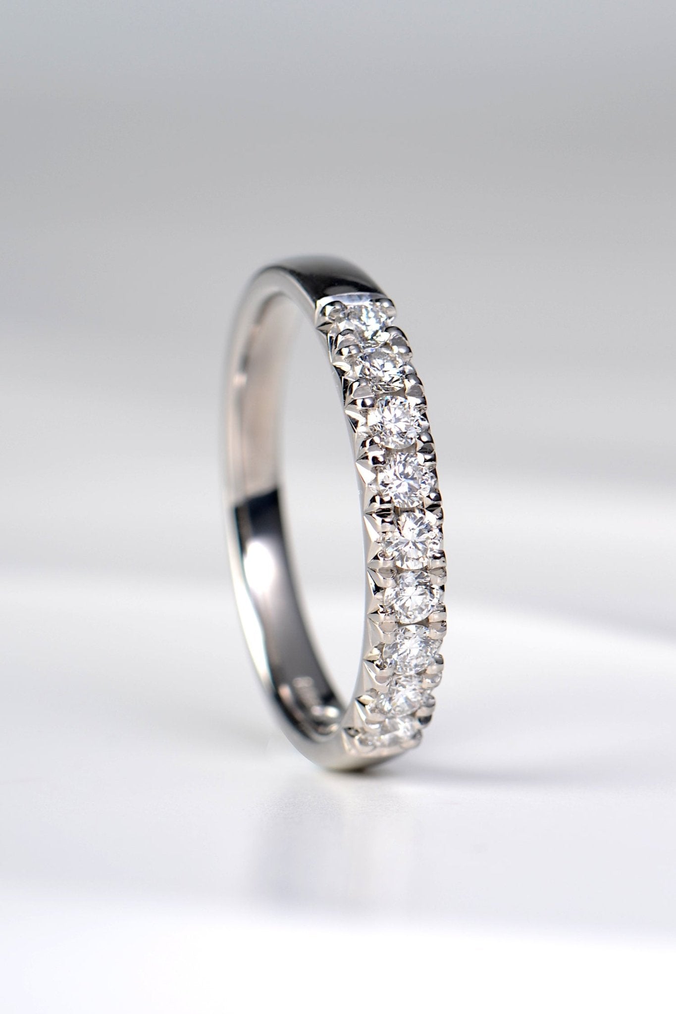 Platinum fishtail diamond wedding band set with nine round brilliant diamonds