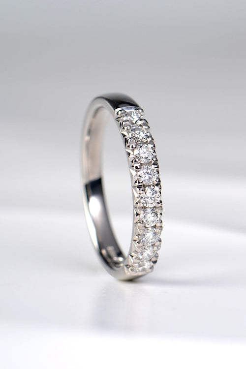 Platinum fishtail diamond wedding band set with nine round brilliant diamonds