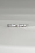 slim platinum wedding ring with a slight curve at the front so that it sits next to an engagement ring that needs a shaped wedding ring.