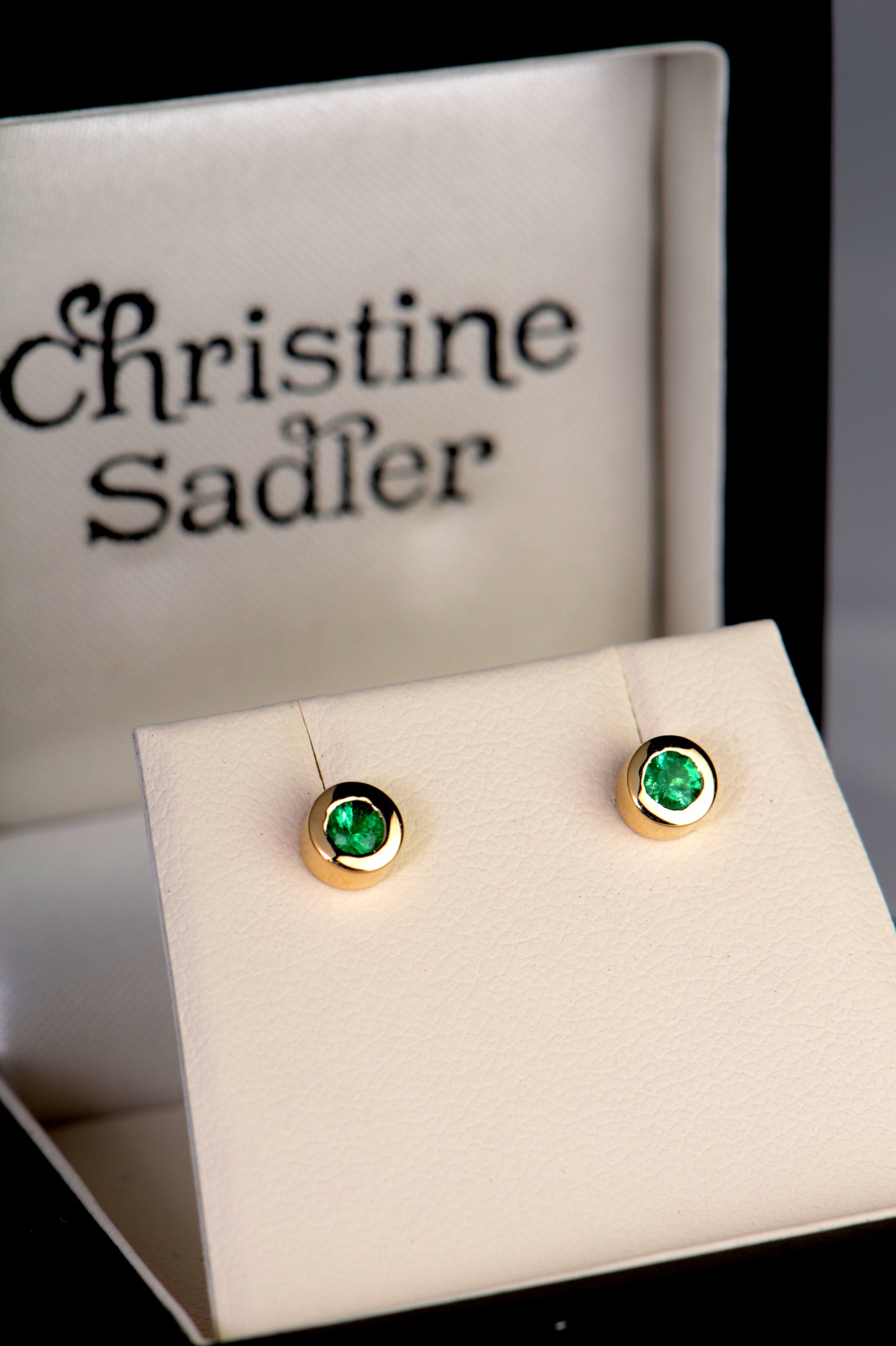 handmade yellow gold emerald stud stud earrings in a presentation box from UK  jewellery designer Christine Sadler who is based in Ayr Scotland