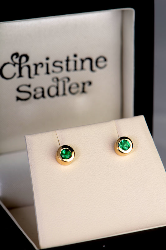 handmade yellow gold emerald stud stud earrings in a presentation box from UK  jewellery designer Christine Sadler who is based in Ayr Scotland