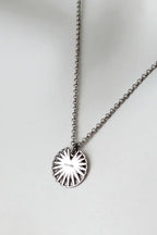 Silver disc talisman pendant necklace engraved with the word Enough