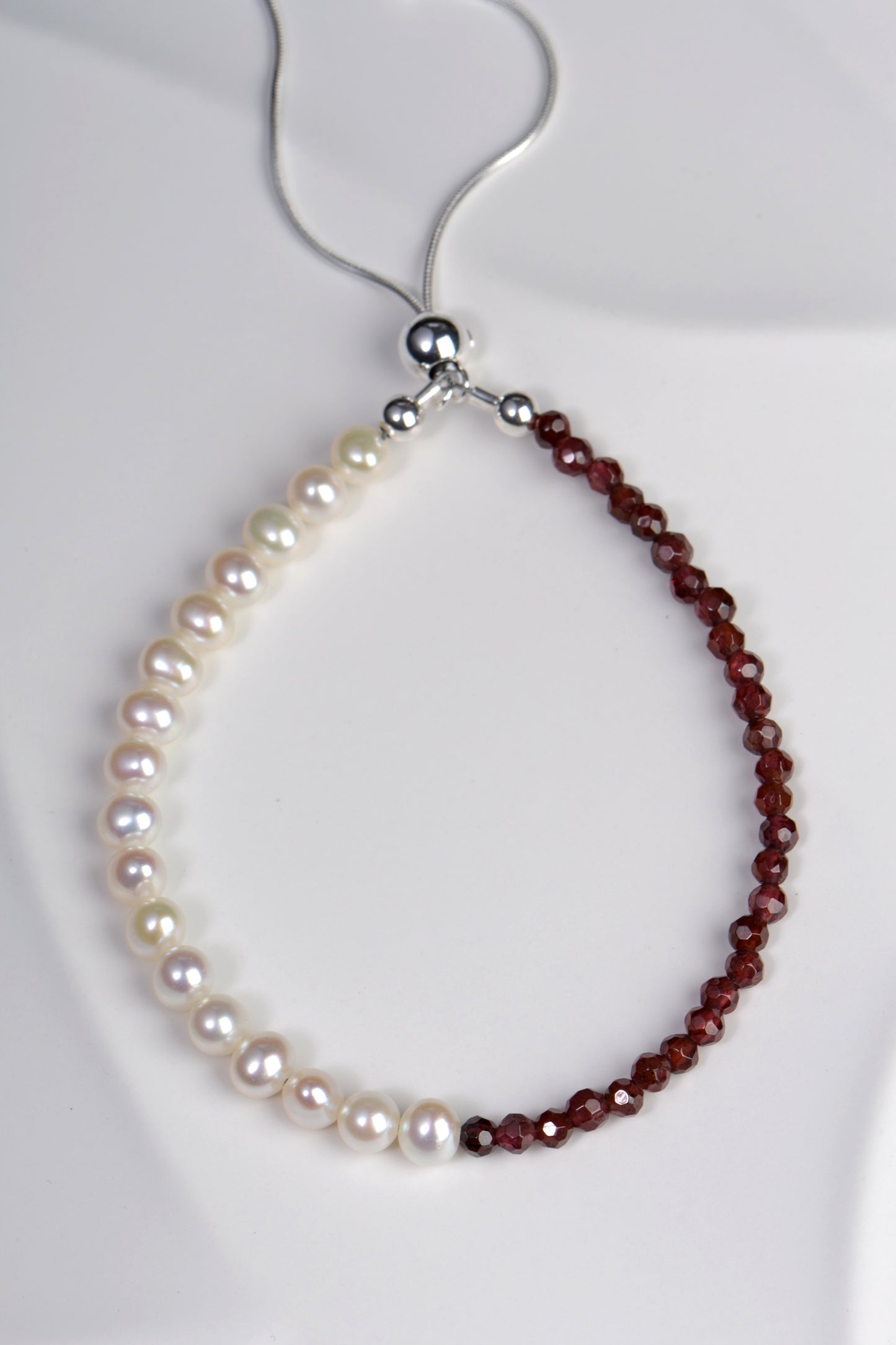 white pearl and garnet protection bracelet