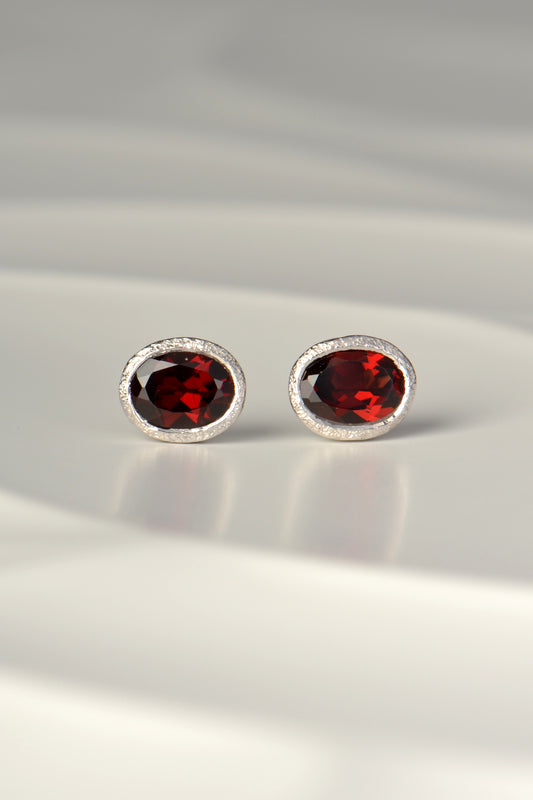 affordable designer silver stud earrings with oval garnets, the birthstone for January