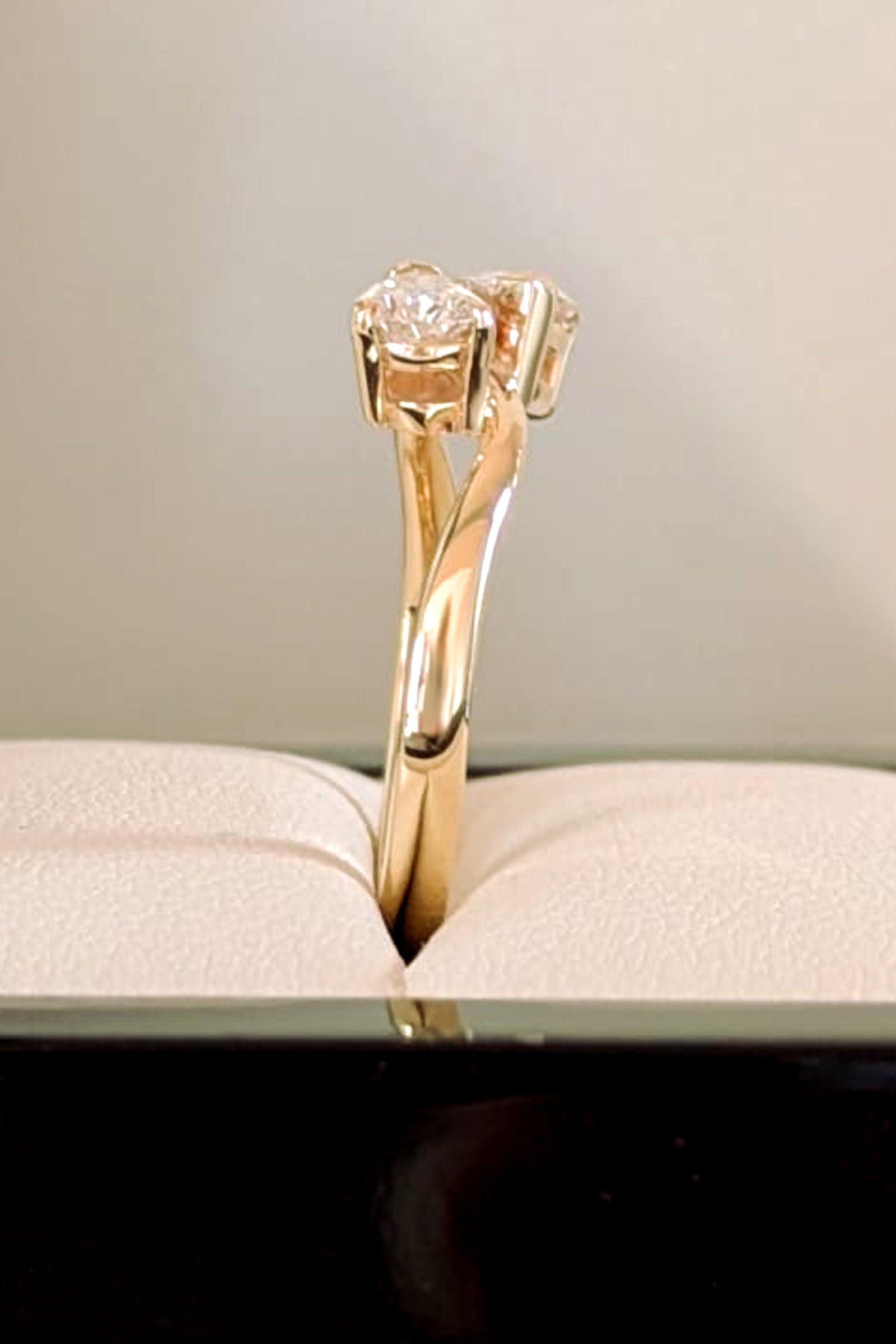 Close-up of pear cut lab diamond ring in 9ct gold showing three-claw setting and curved wave band - Christine Sadler