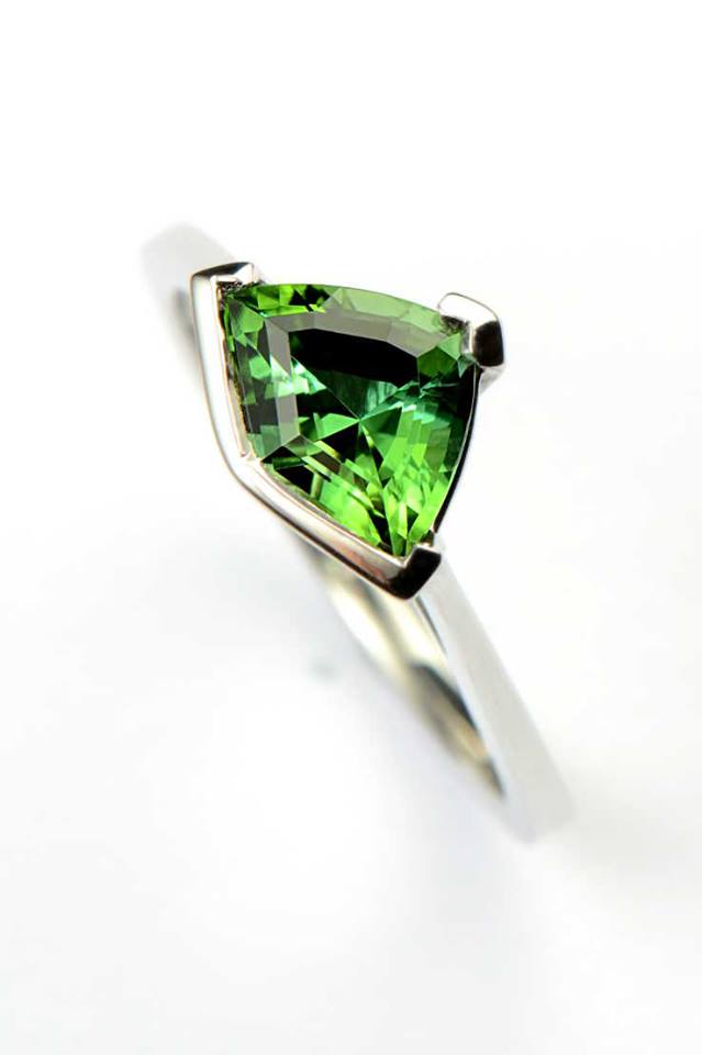 Shield shaped strong green tourmaline ring in platinum from Christine Sadler's Sailing Stones collection of jewellery