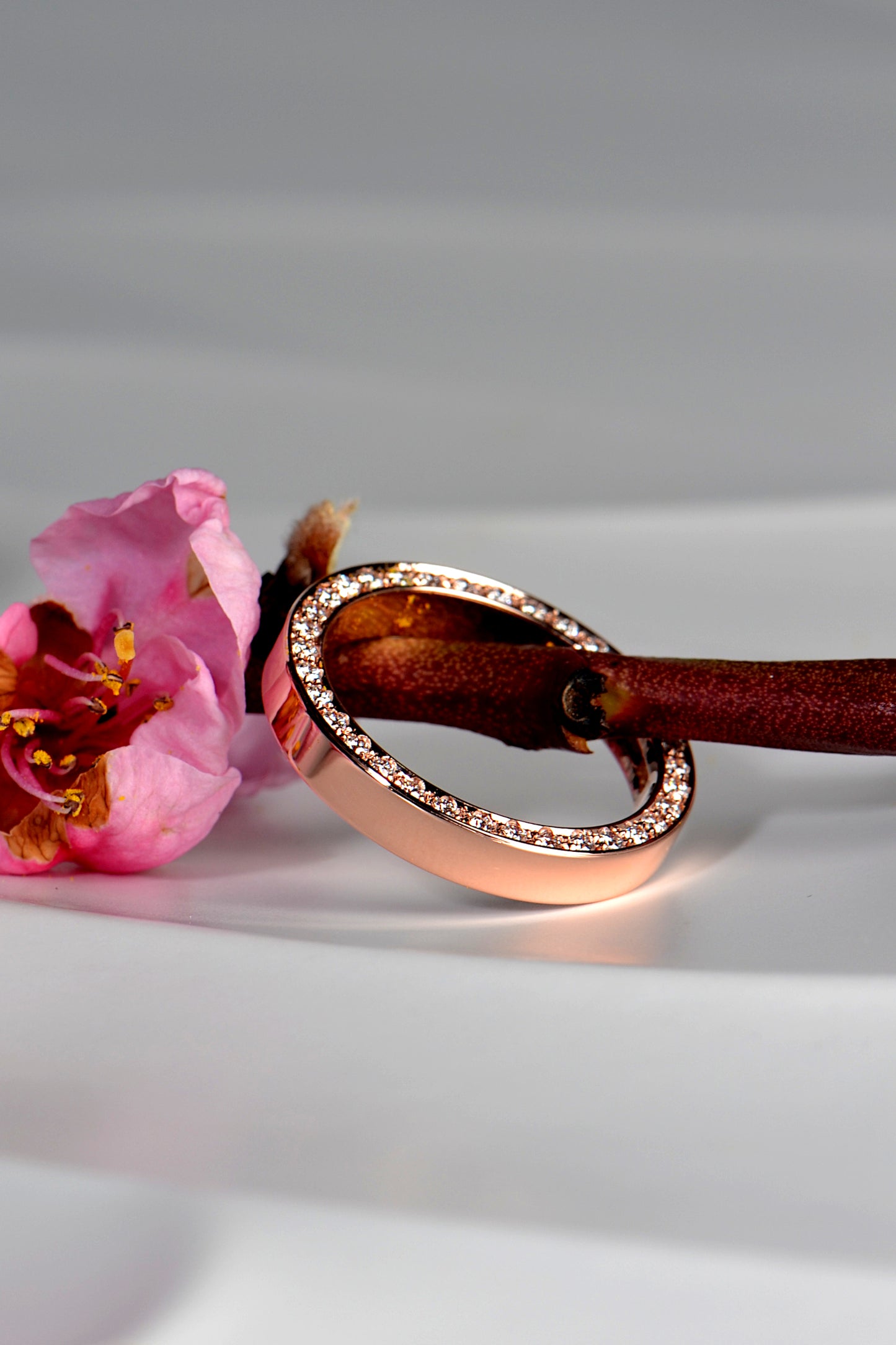 unusual diamond wedding ring in rose gold wtih diamonds all the way round the side