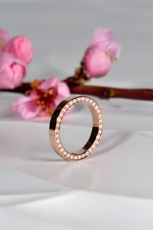 contemporary british rose gold wedding ring with diamonds on the side