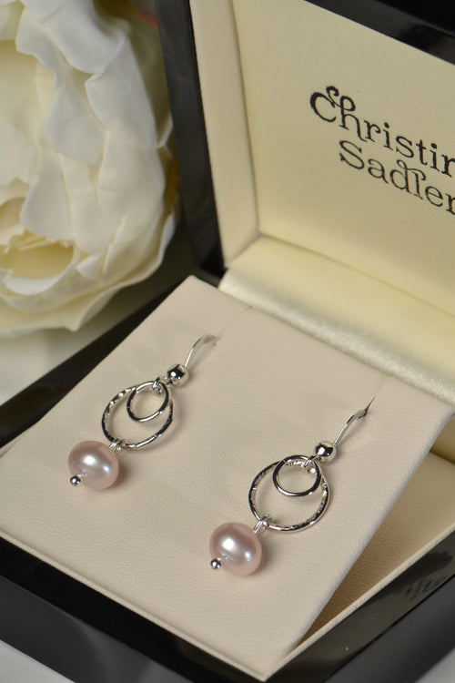 Sterling silver earrings with pink cultured pearls in a Christine Sadler box.