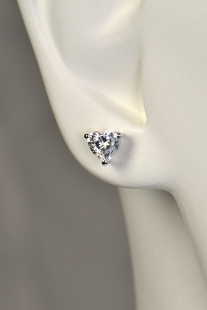 Heart-shaped sparkling earring on a mannequin ear