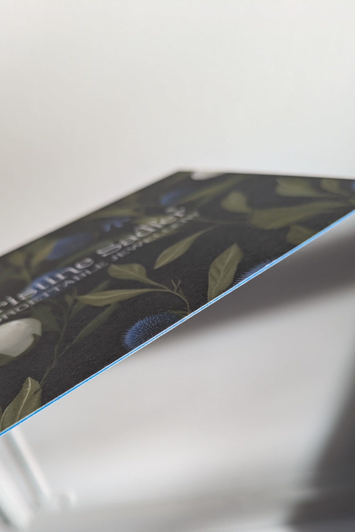 Christine Sadler gift voucher printed on uncoated, naturally textured Mohawk Superfine paper, 600gsm double thickness with stylish blue detail in the middle.