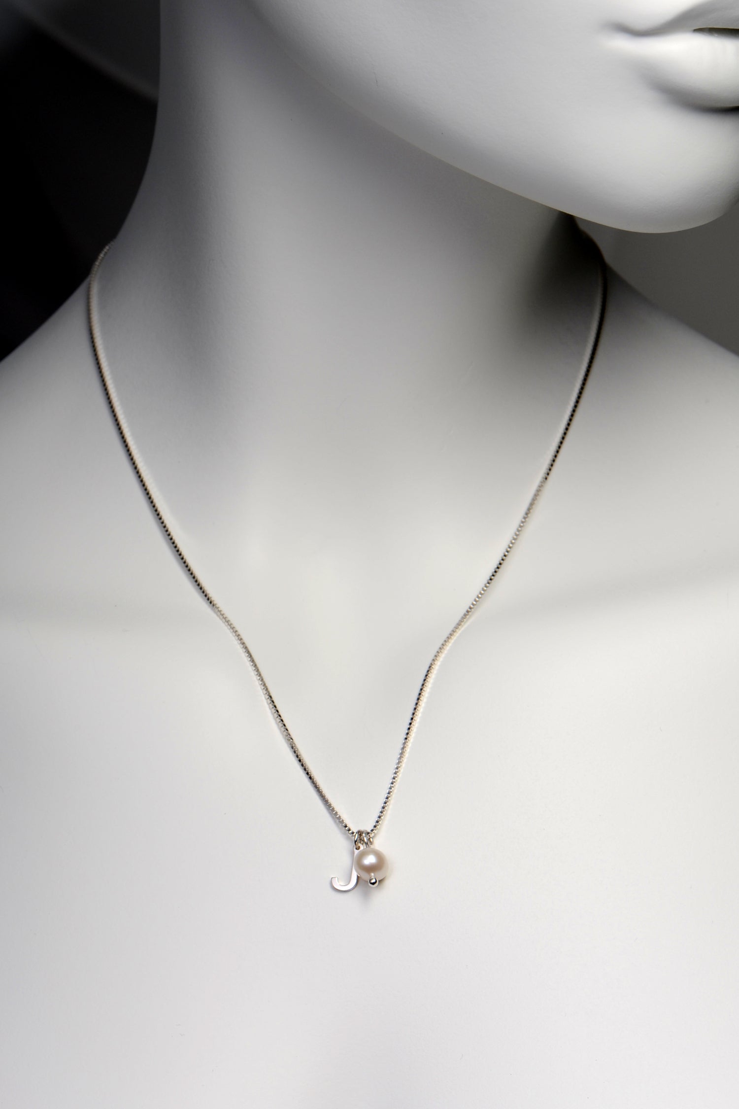 small real silver initial pendant with a real pearl on a sterling silver chain from Christine Sadler