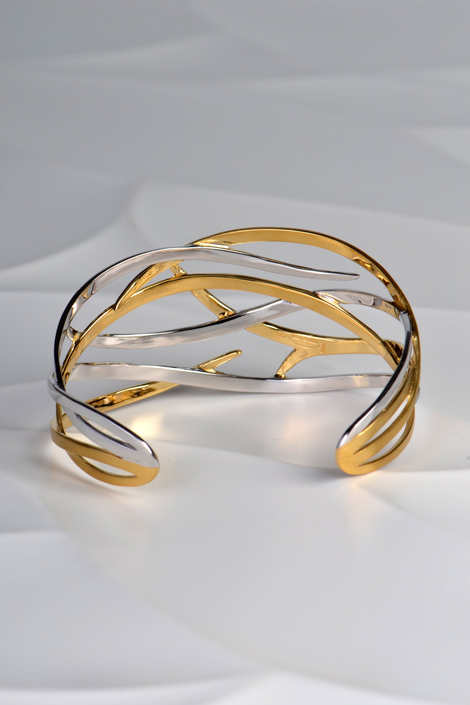 elegant ribbons of silver and 18ct gold plate overlap in this stunning cuff bangle design