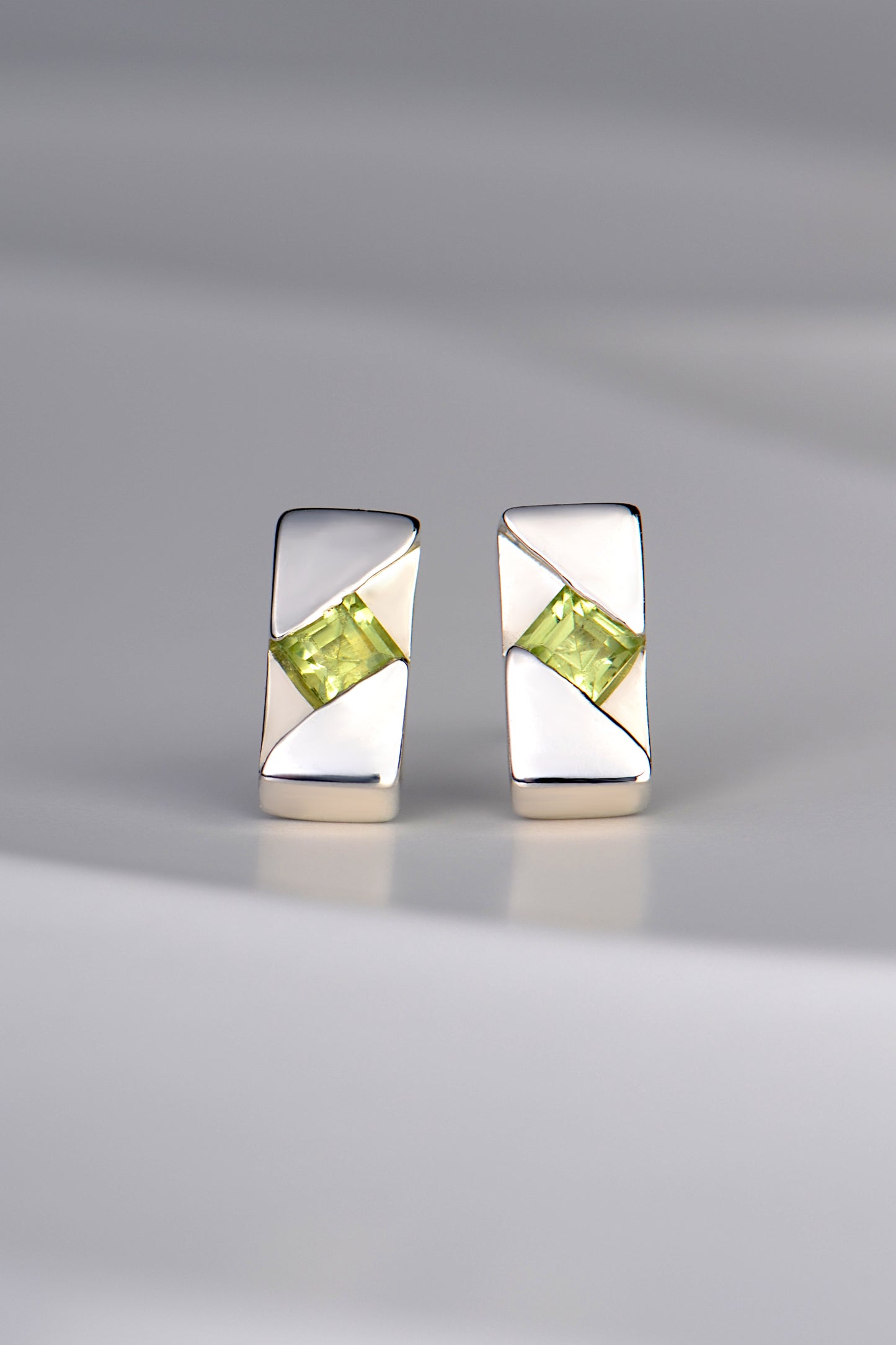 rectangular silver handmade earrings set with a square peridot