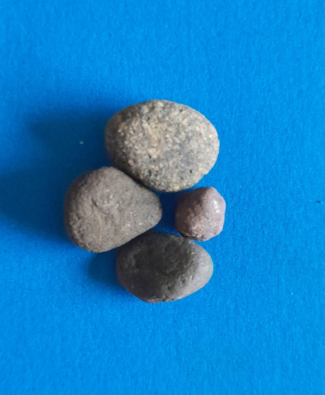 Four pebbles used as inspiration for a unique high end jewellery commission of four diamond stacking rings