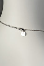 close up detail of extendable chain with Christine Sadler's benchmark logo