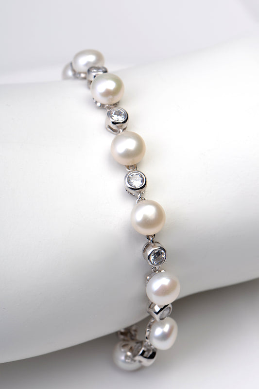 Sterling silver bracelet with alternating white cultured pearls and sparkling cubic zirconias. 