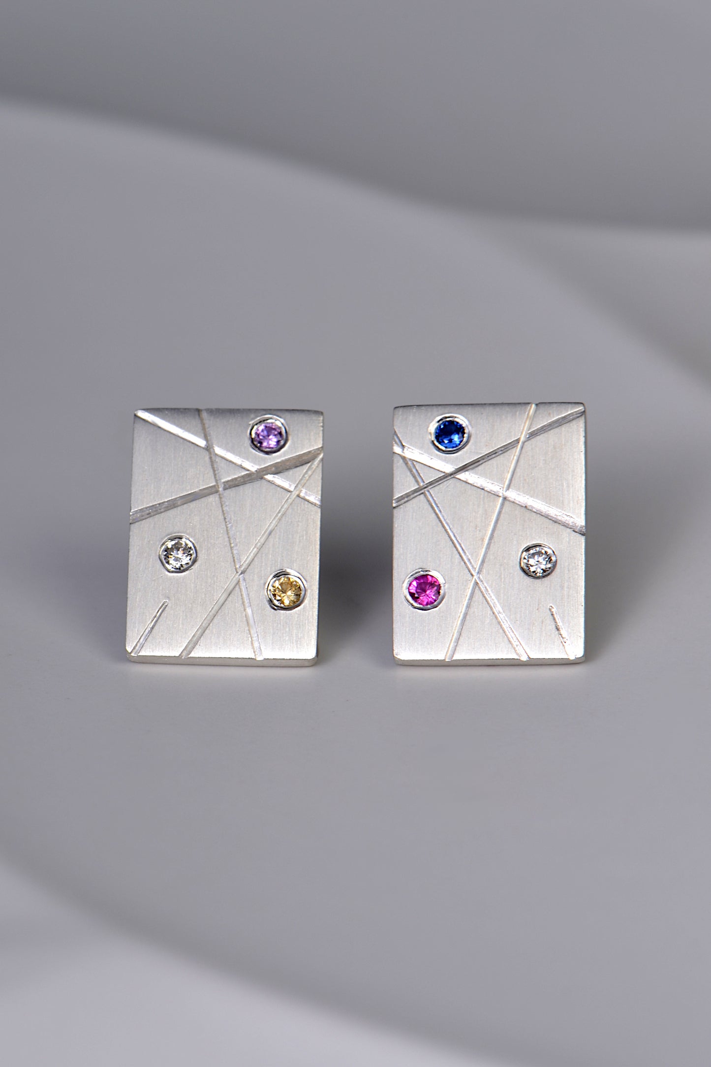 silver rectangular earrings set with coloured sapphires and diamonds
