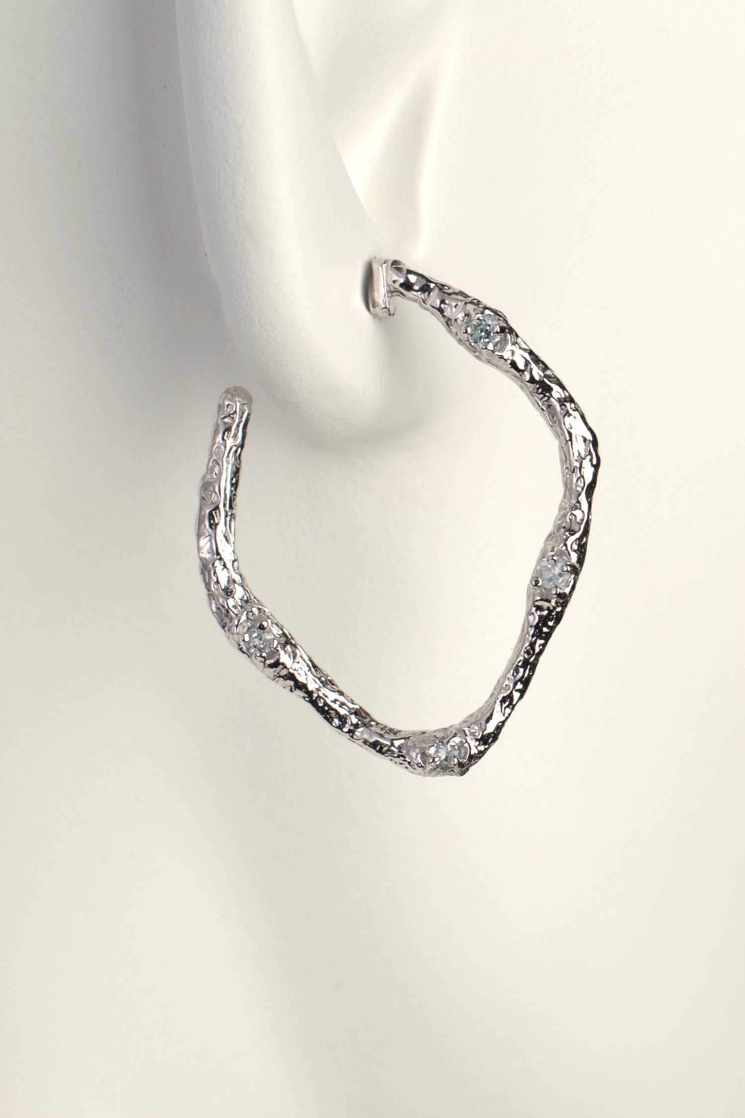 stylish contemporary large real silver designer hoop earrings set with blue topaz gemstone