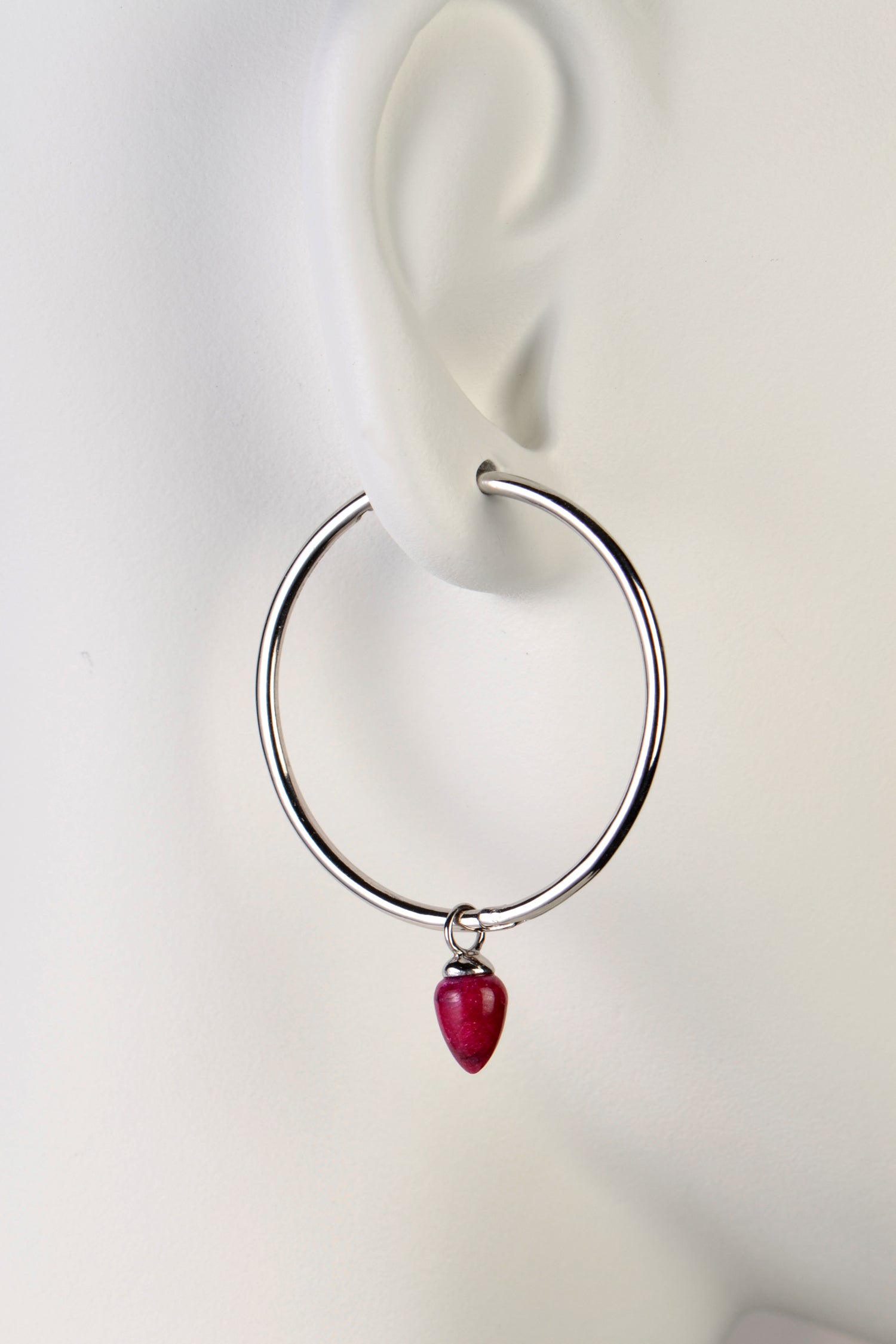 Large sterling silver designer hoop earring with a ruby by jewellery designer Jorge Revilla