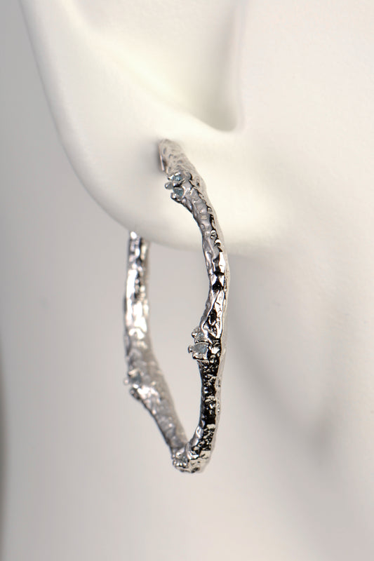 organic textured large silver hoop designer earrings that are really different from jewellery designer Jorge Revilla