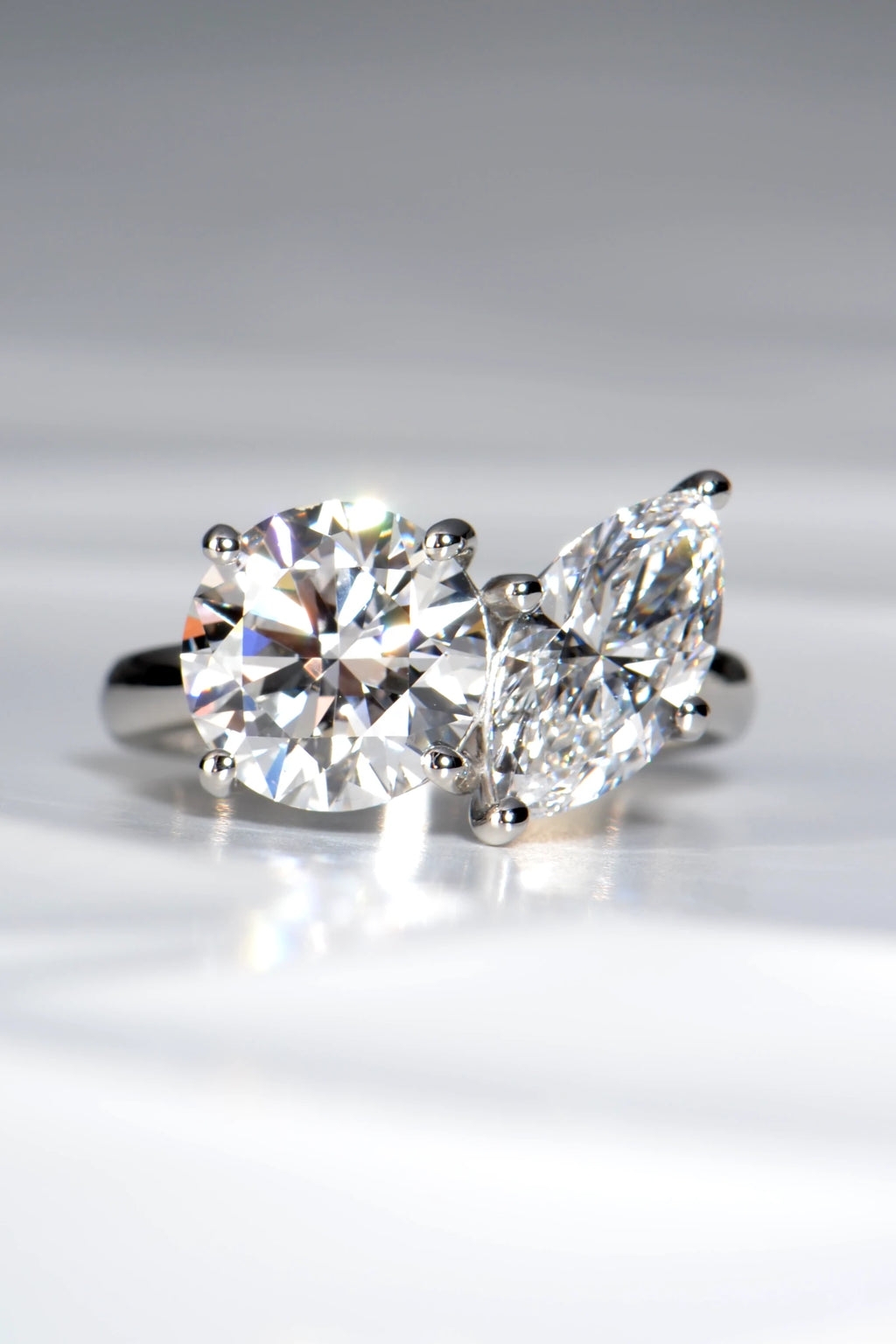 Handcrafted Toi et Moi lab diamond engagement ring, marquise cut and round, in hallmarked platinum 950 on a crisp white background by Christine Sadler
