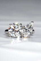 Handcrafted Toi et Moi lab diamond engagement ring, marquise cut and round, in hallmarked platinum 950 on a crisp white background by Christine Sadler