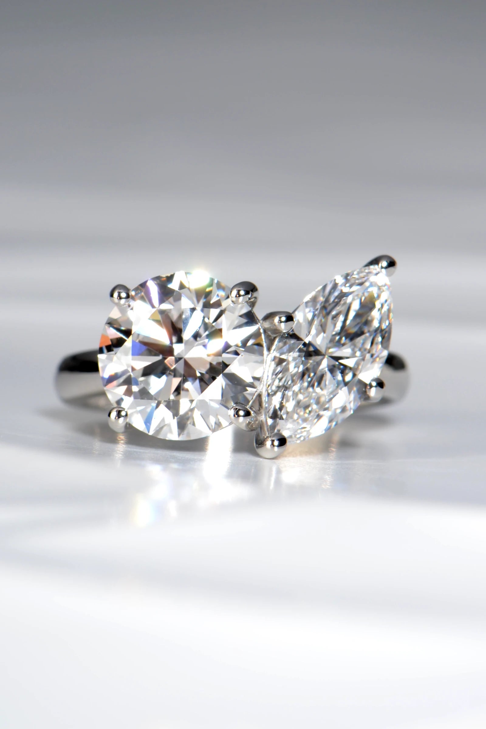Handcrafted Toi et Moi lab diamond engagement ring, marquise cut and round, in hallmarked platinum 950 on a crisp white background by Christine Sadler