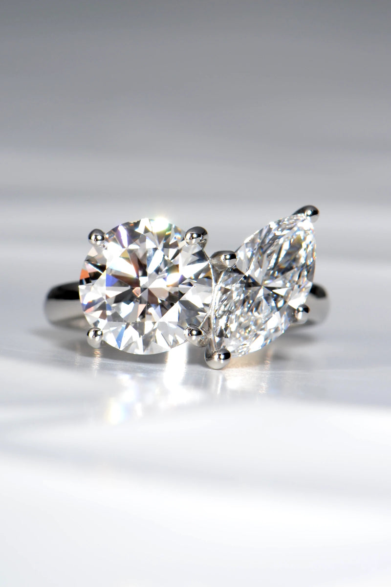 Handcrafted Toi et Moi lab diamond engagement ring, marquise cut and round, in hallmarked platinum 950 on a crisp white background by Christine Sadler