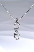 Close-up of sterling silver DNA double helix necklace pendant on a white background - Christine Sadler