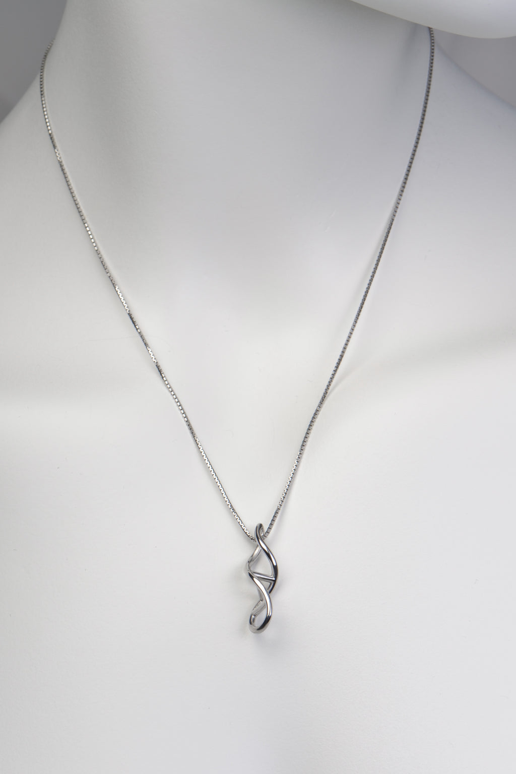 Front view of dna double helix necklace on white mannequin bust against plain background - Christine Sadler