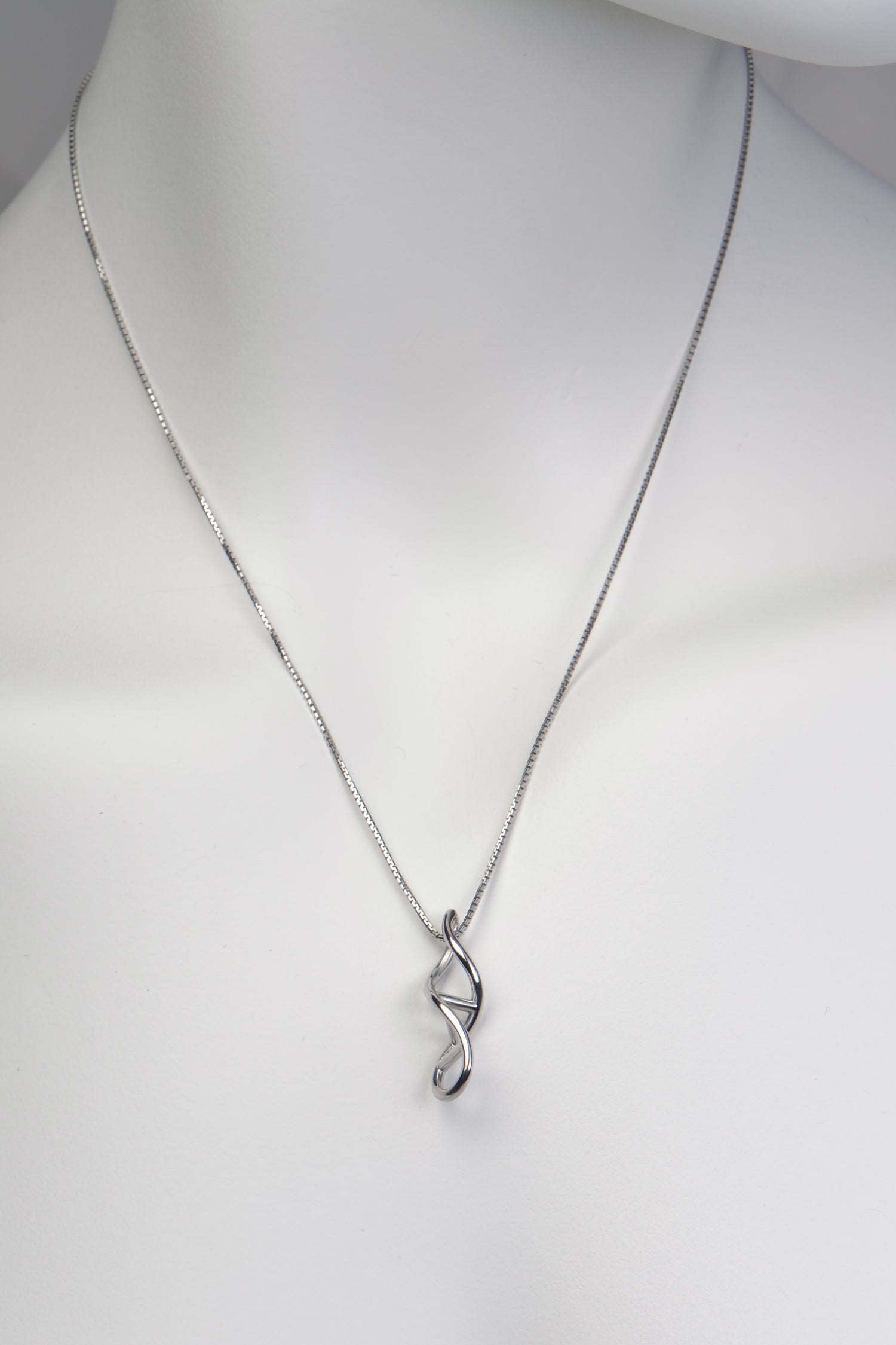 Front view of dna double helix necklace on white mannequin bust against plain background - Christine Sadler