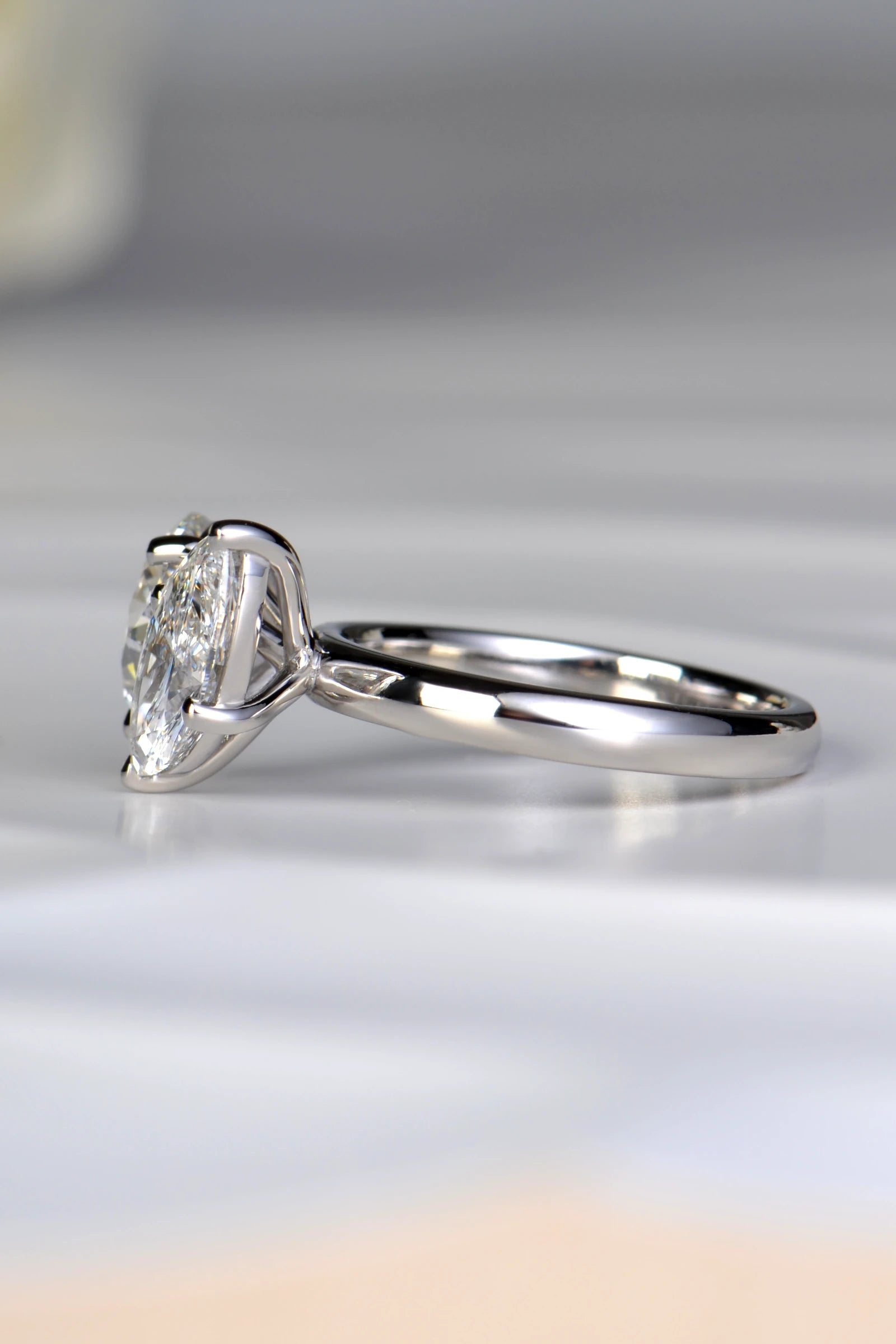 Side angle view of a 1.54ct marquise cut lab diamond set at a dynamic 45 degree angle on a premium platinum band by Christine Sadler