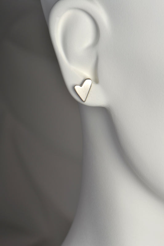 gorgeous handmade asymmetric heart earrings in brushed silver. The earrings cover the full earlobe