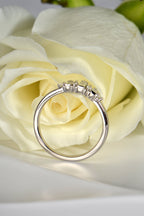 high quality British platinum and diamond ring with a white rose in the background