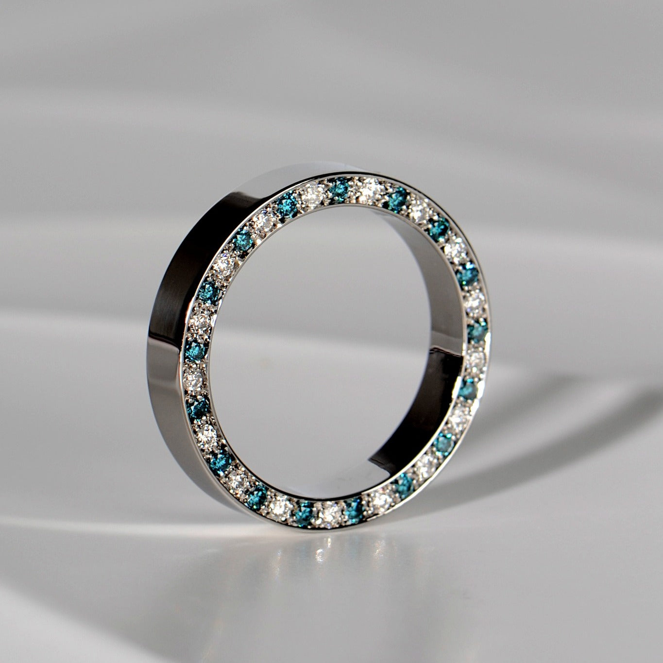 unique platinum wedding ring commission with alternating blue and white diamonds on one side - Christine Sadler