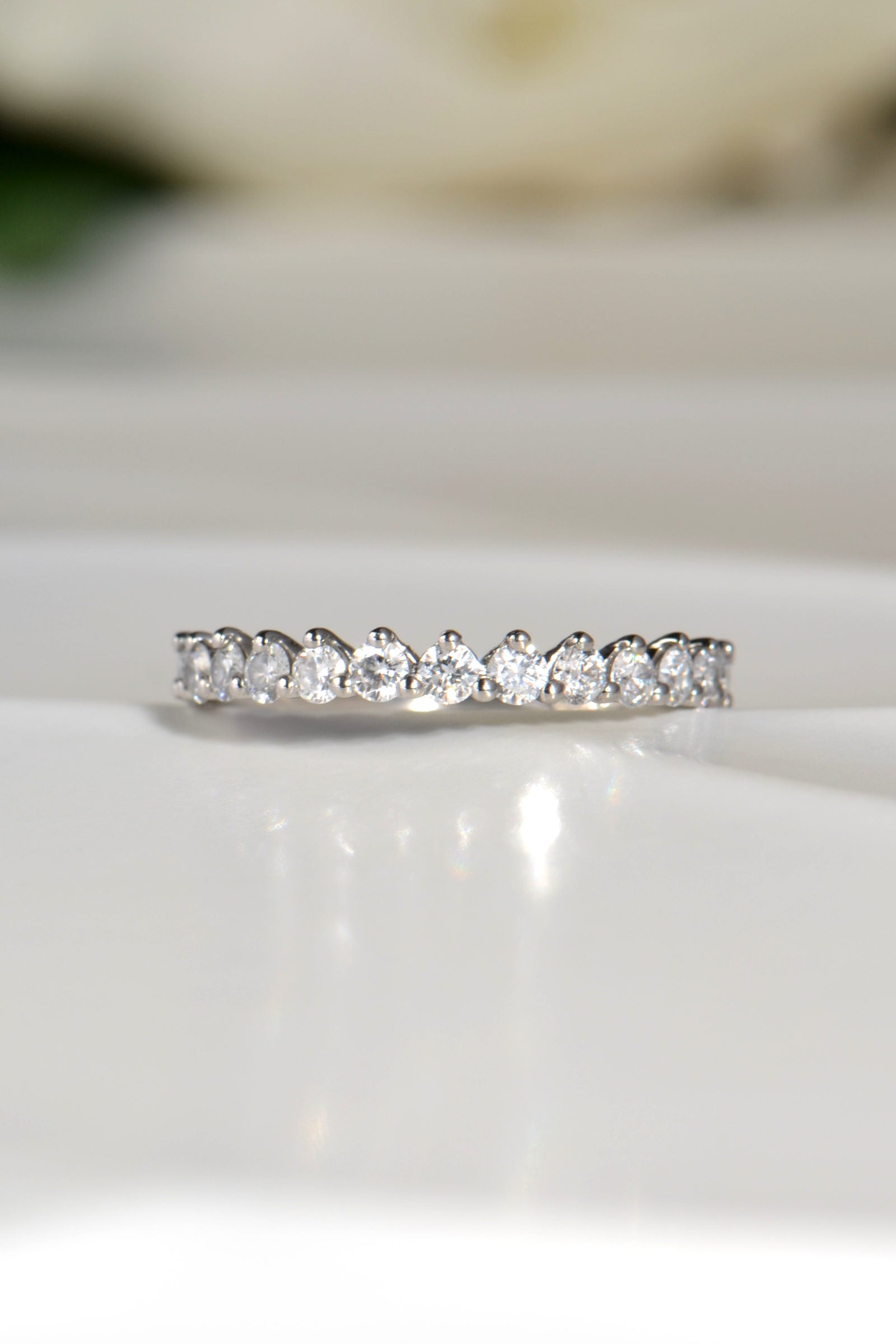 delicate asymmetric diamond wedding ring with 15 brilliant cut diamonds and shared claw setting in platinum - Christine Sadler