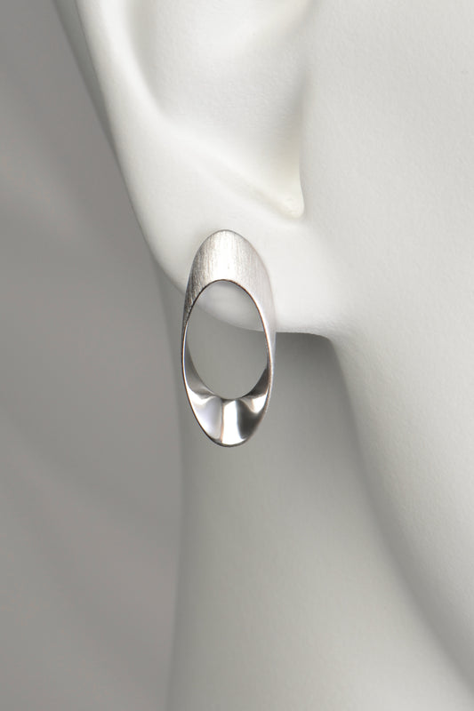 modern large silver designer stud earrings that have a post and scroll fitting. Matt and polished finish.