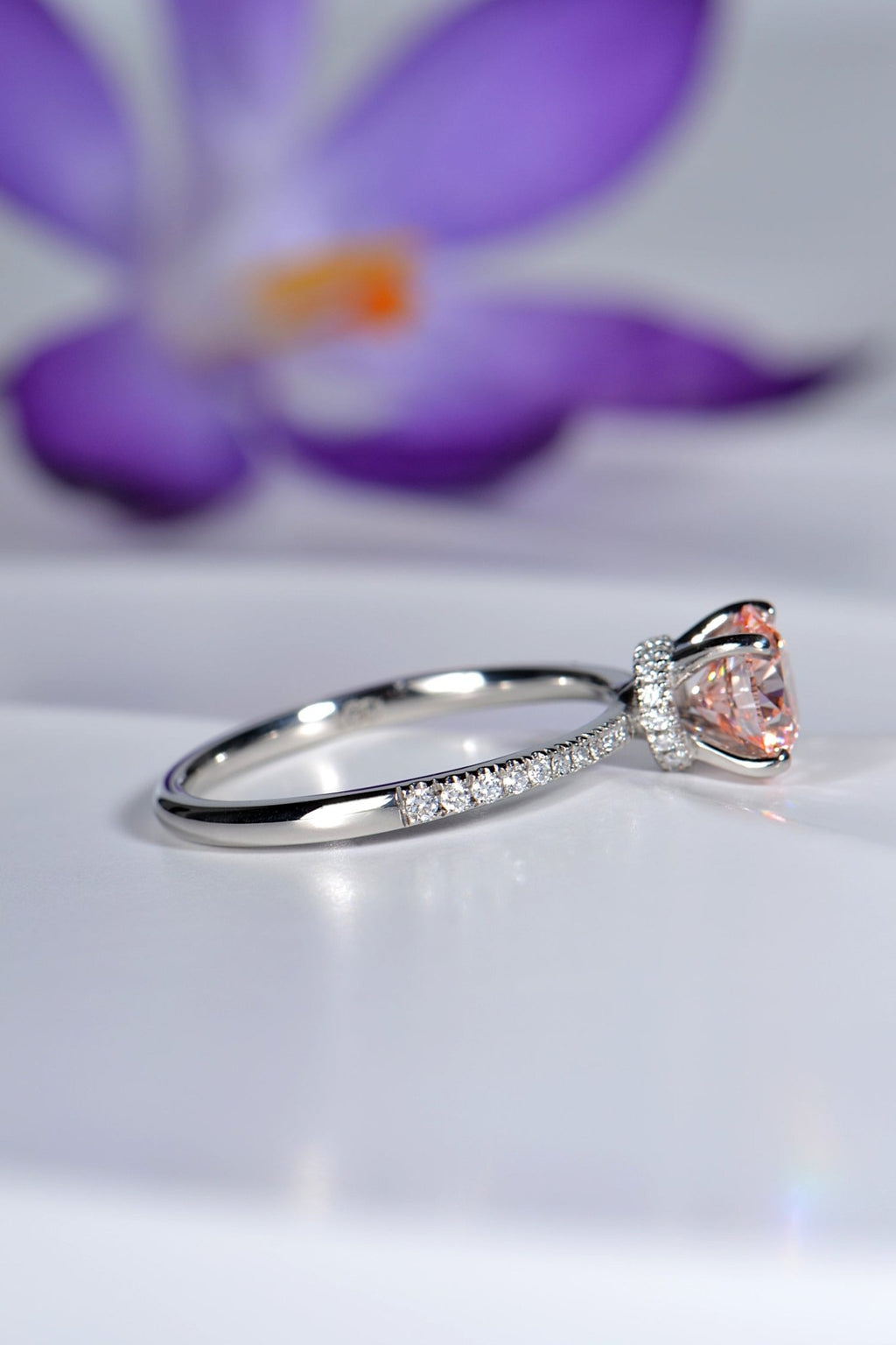 modern pink lab diamond platinum engagement ring with crocus flower in background