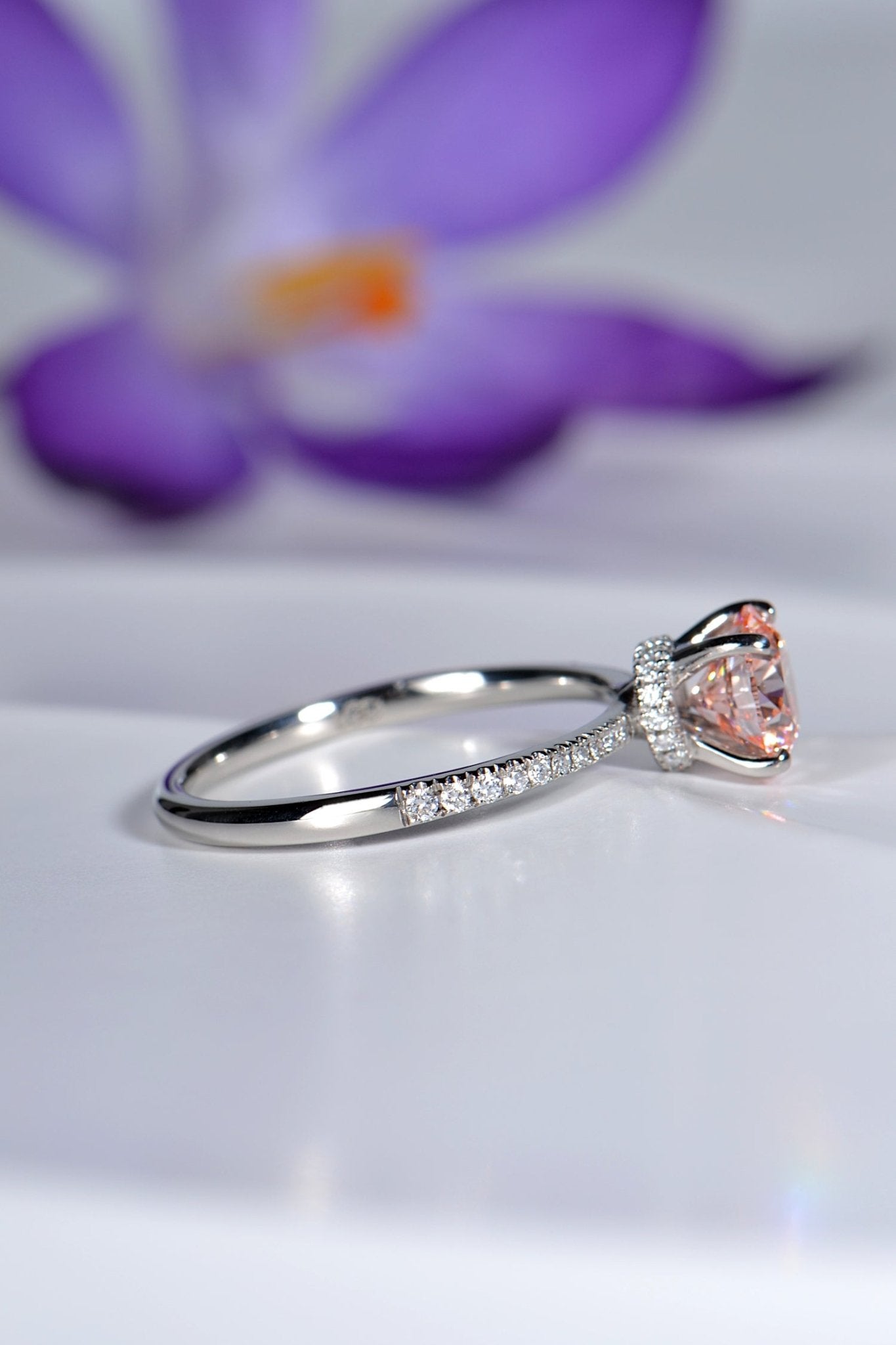 modern pink lab diamond platinum engagement ring with crocus flower in background