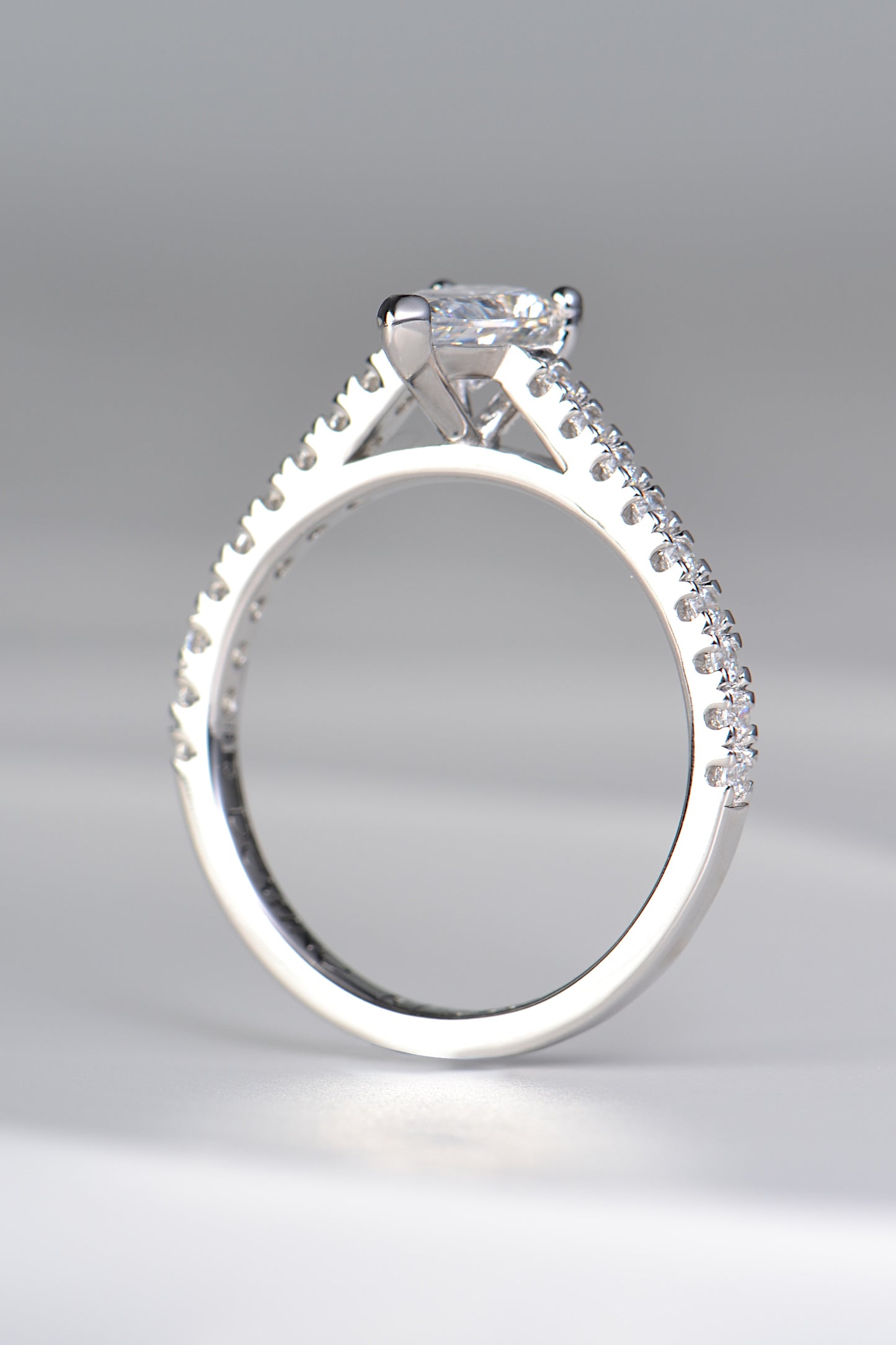 contemporary pear cut diamond engagement ring with diamonds in the shoulders available in mined or lab grown diamonds