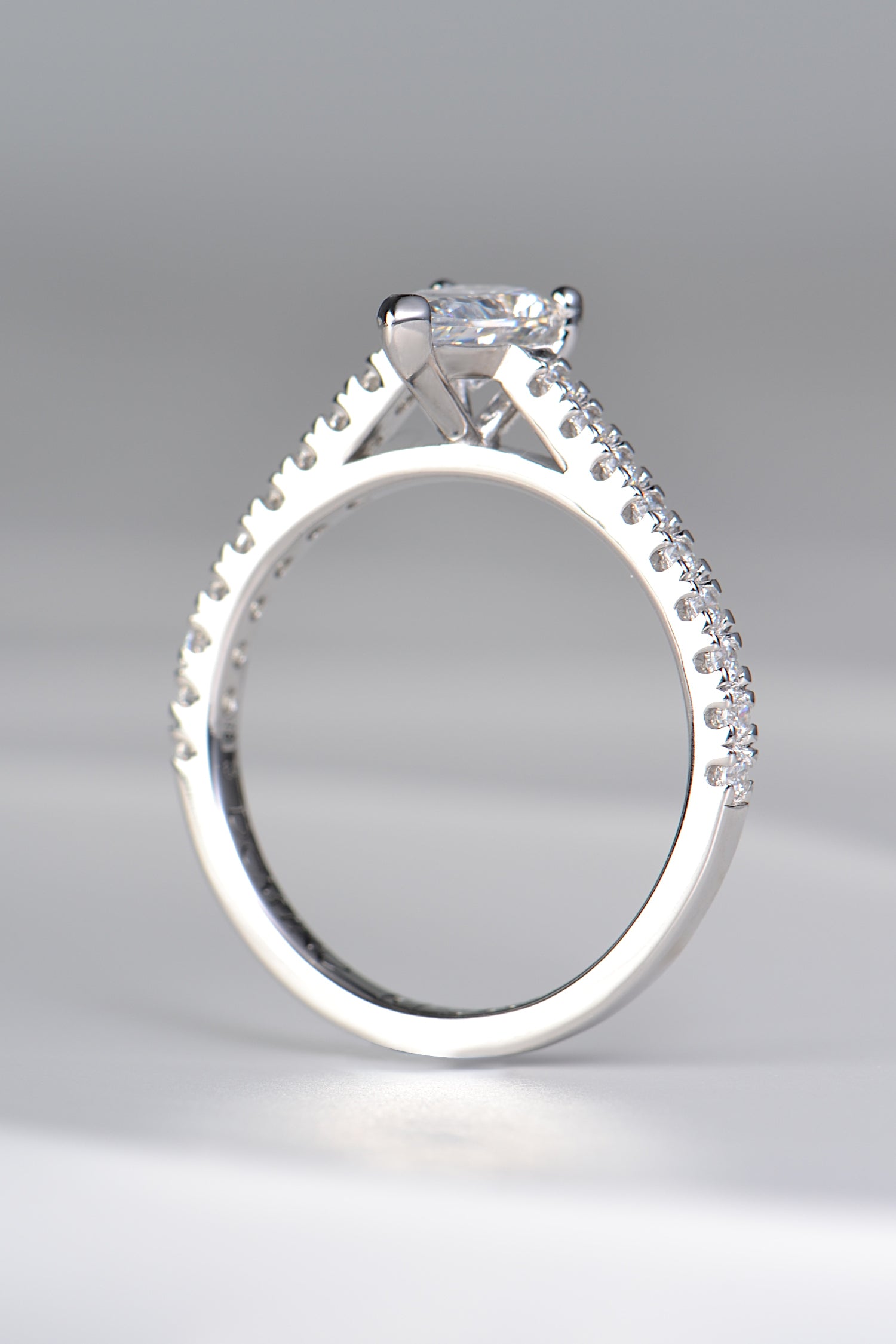 contemporary pear cut diamond engagement ring with diamonds in the shoulders available in mined or lab grown diamonds