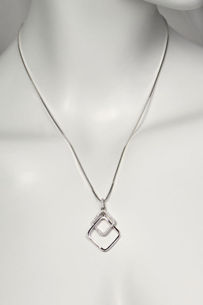 Silver sparkly necklace with a geometric pendant on a mannequin against a white background