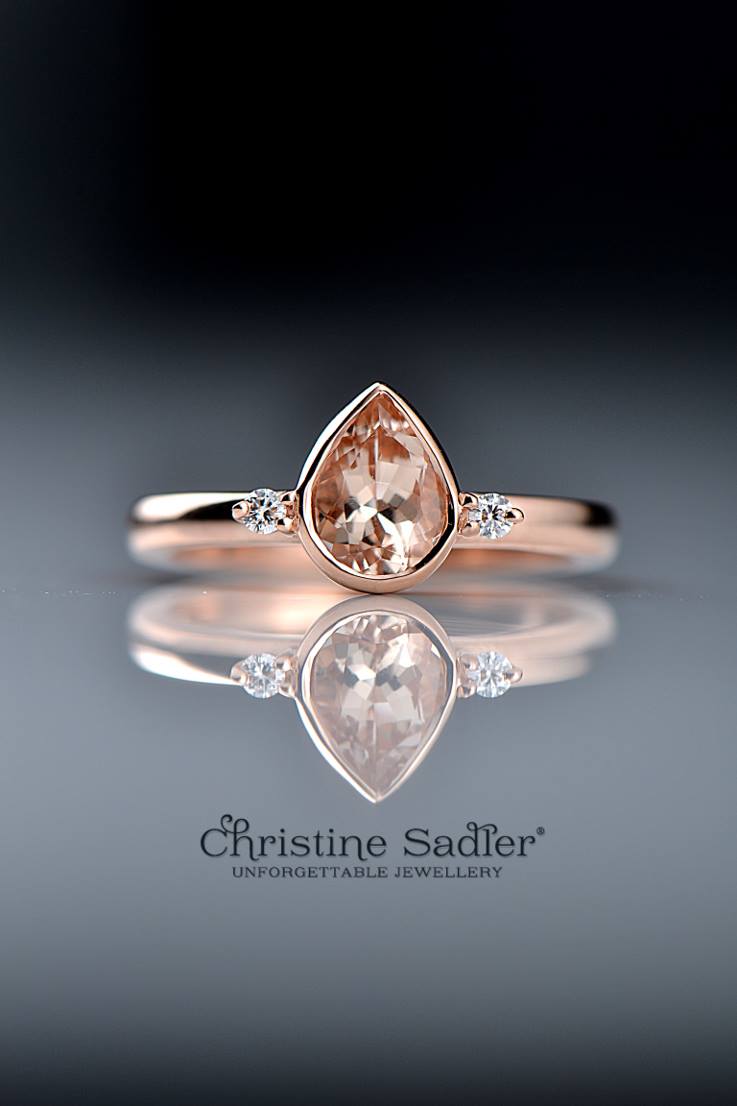 pear cut morganite ring in rose gold with two small claw set diamonds